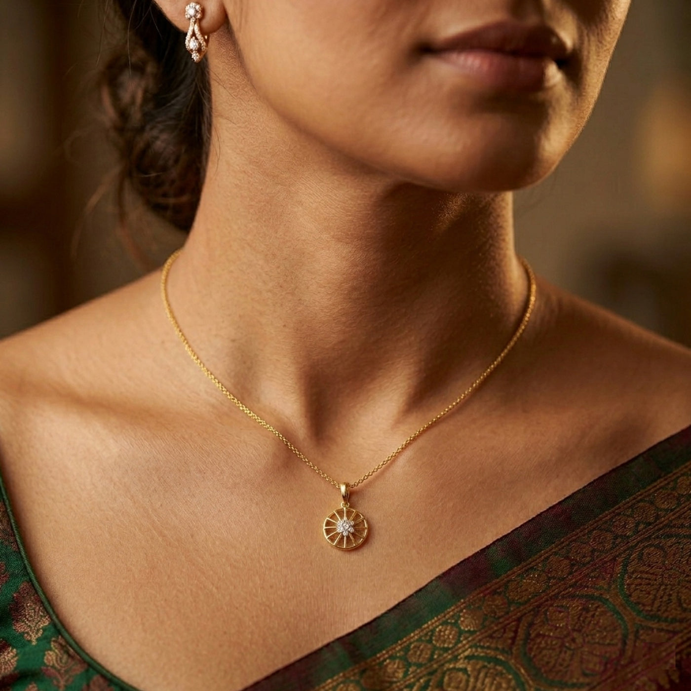 Woman wearing a gold and diamond pendant, blurred background