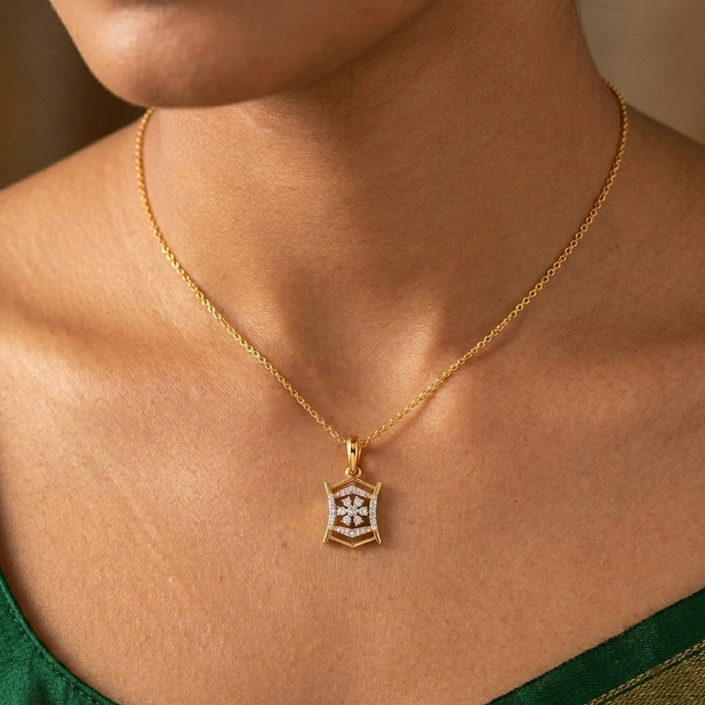 Gold and pendant on a women wearing a green top.