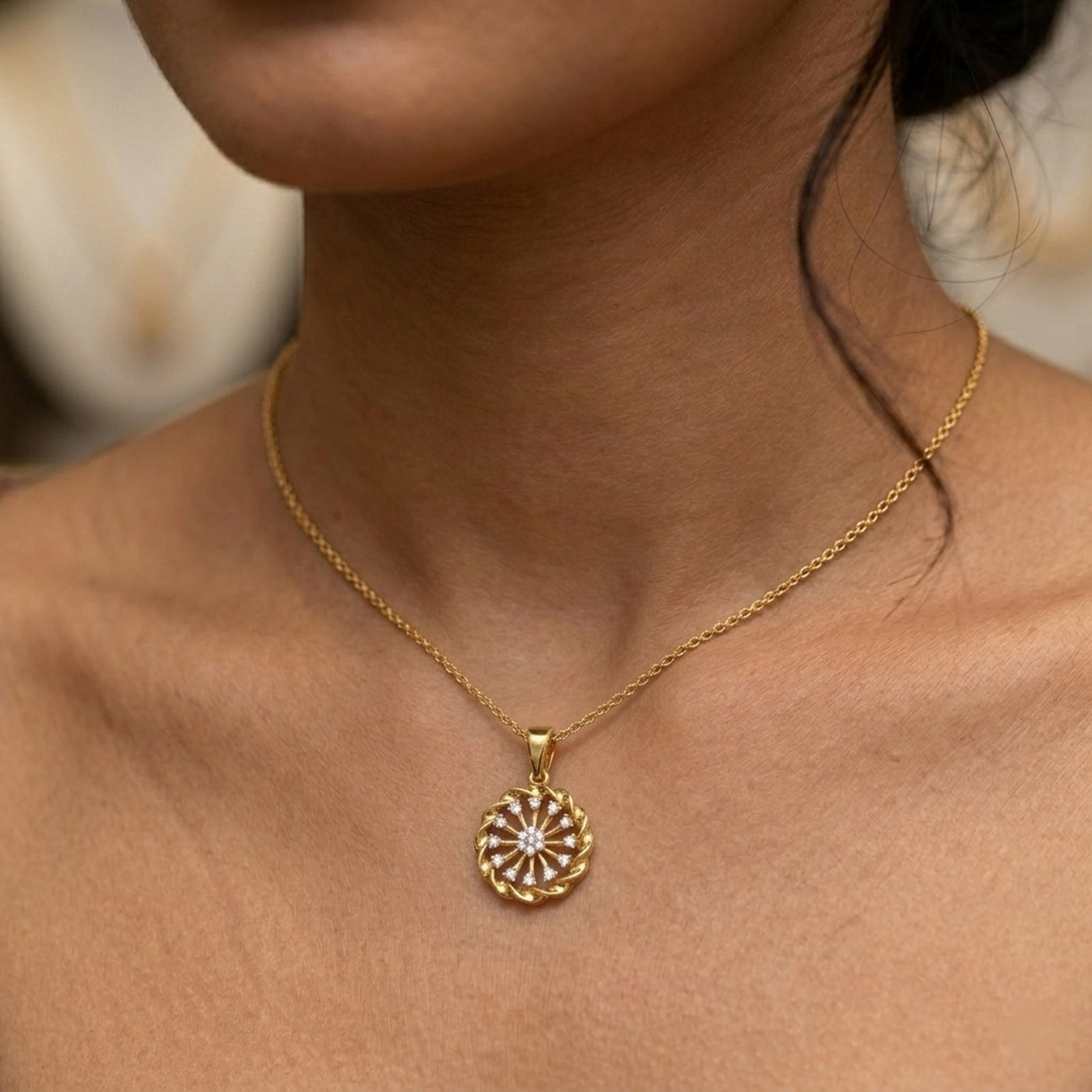 Gold necklace with a circular pendant on a person's neck