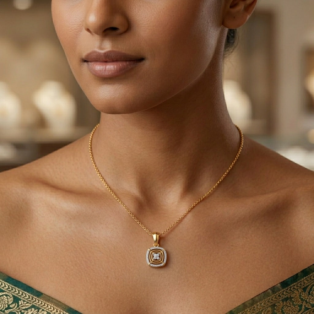 Close-up of a woman wearing a gold necklace with a square pendant.