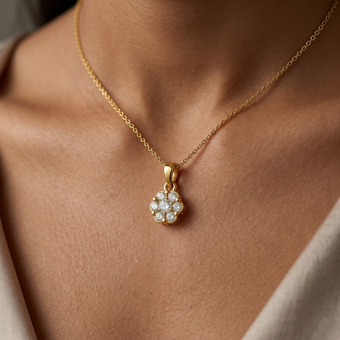Gold necklace with a diamond pendant on a person's neck