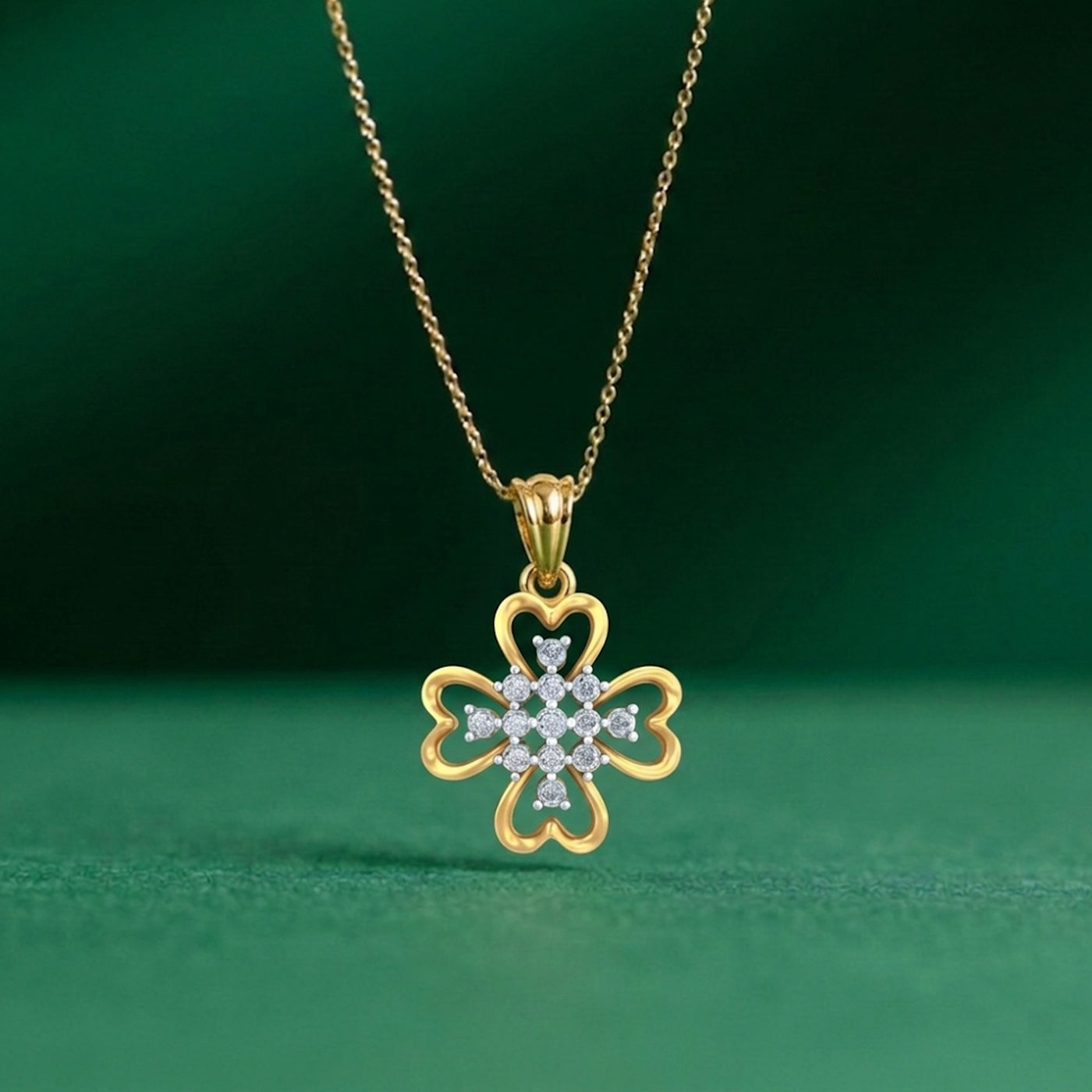 Gold necklace with a clover-shaped pendant on a green background