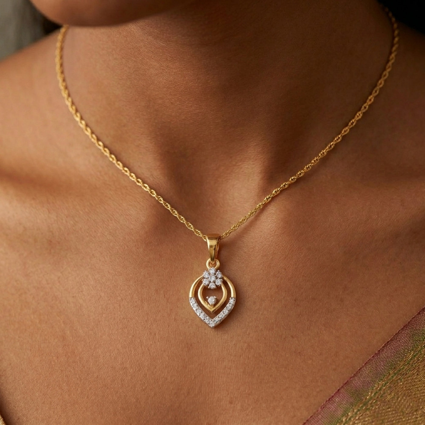 Gold necklace with a heart-shaped pendant on a person's neck