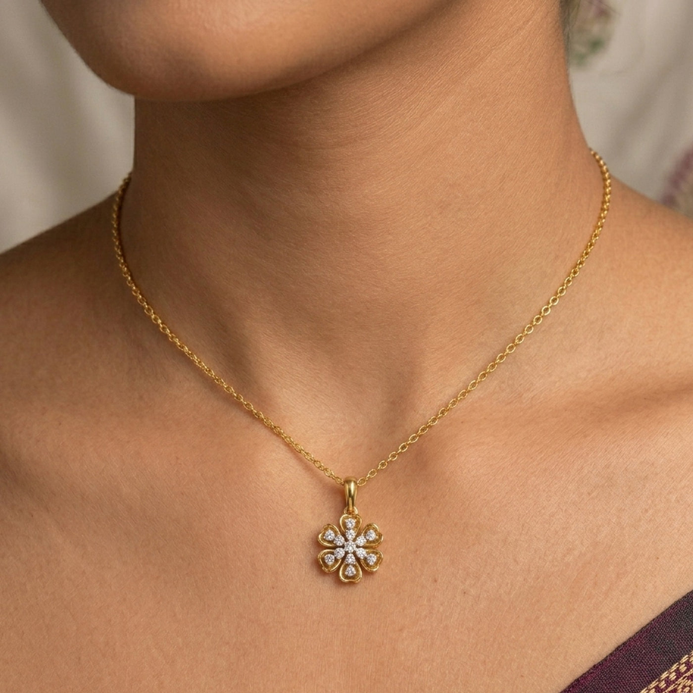 Gold necklace with a diamond pendant on a person's neck