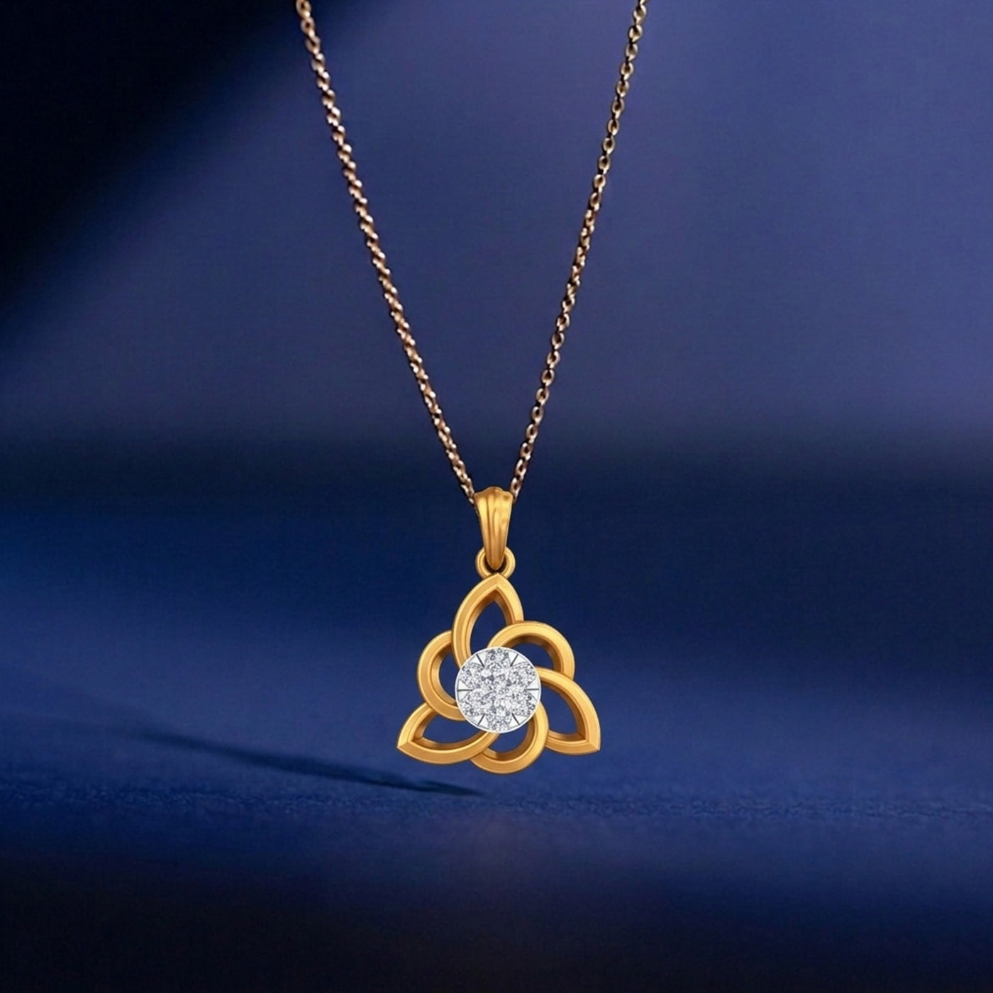 Gold necklace with a diamond pendant on a blue background
