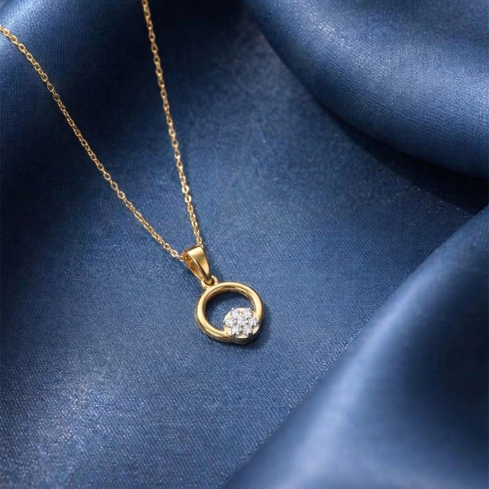 Gold necklace with a diamond pendant on a blue fabric background