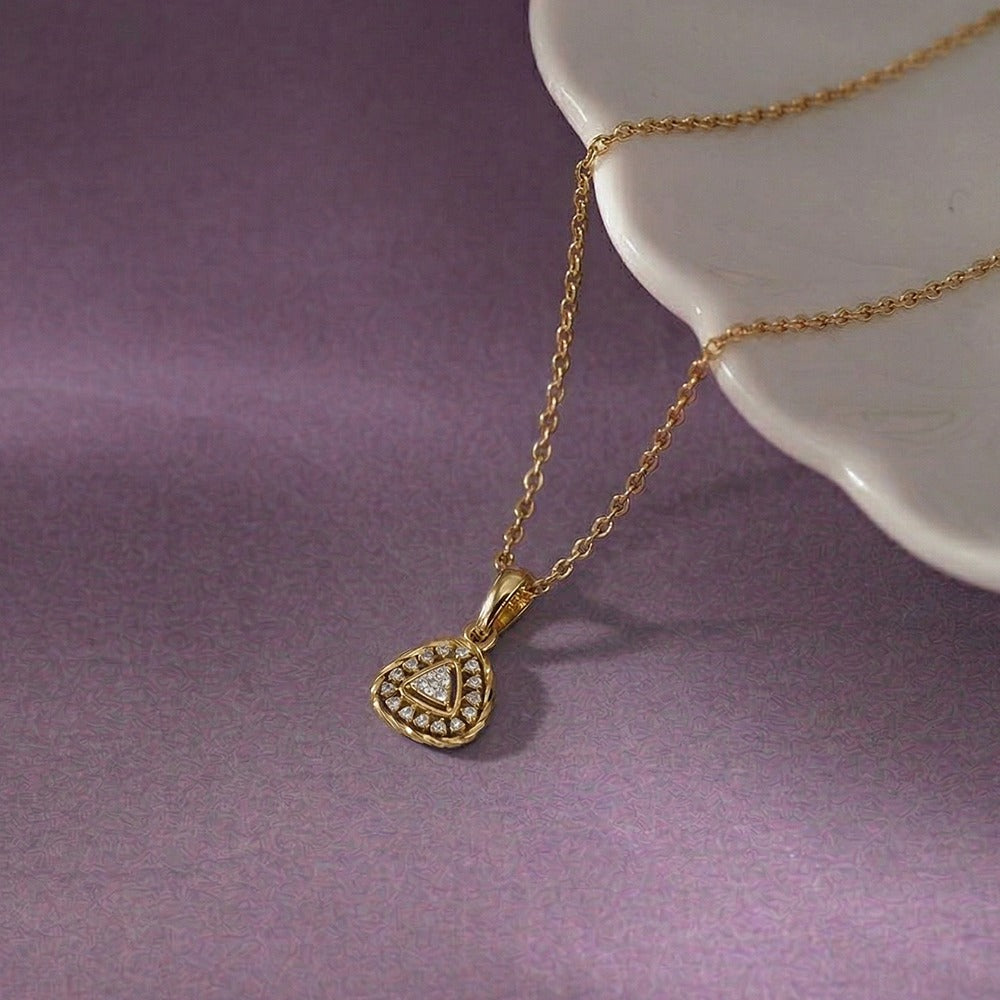 Yellow gold and diamond pendant on purple background