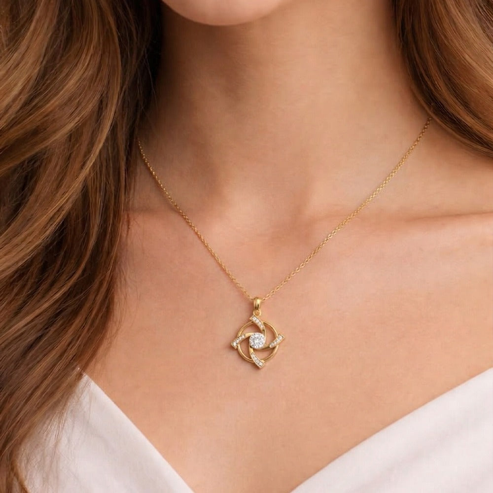 Gold necklace with a diamond pendant worn by a person