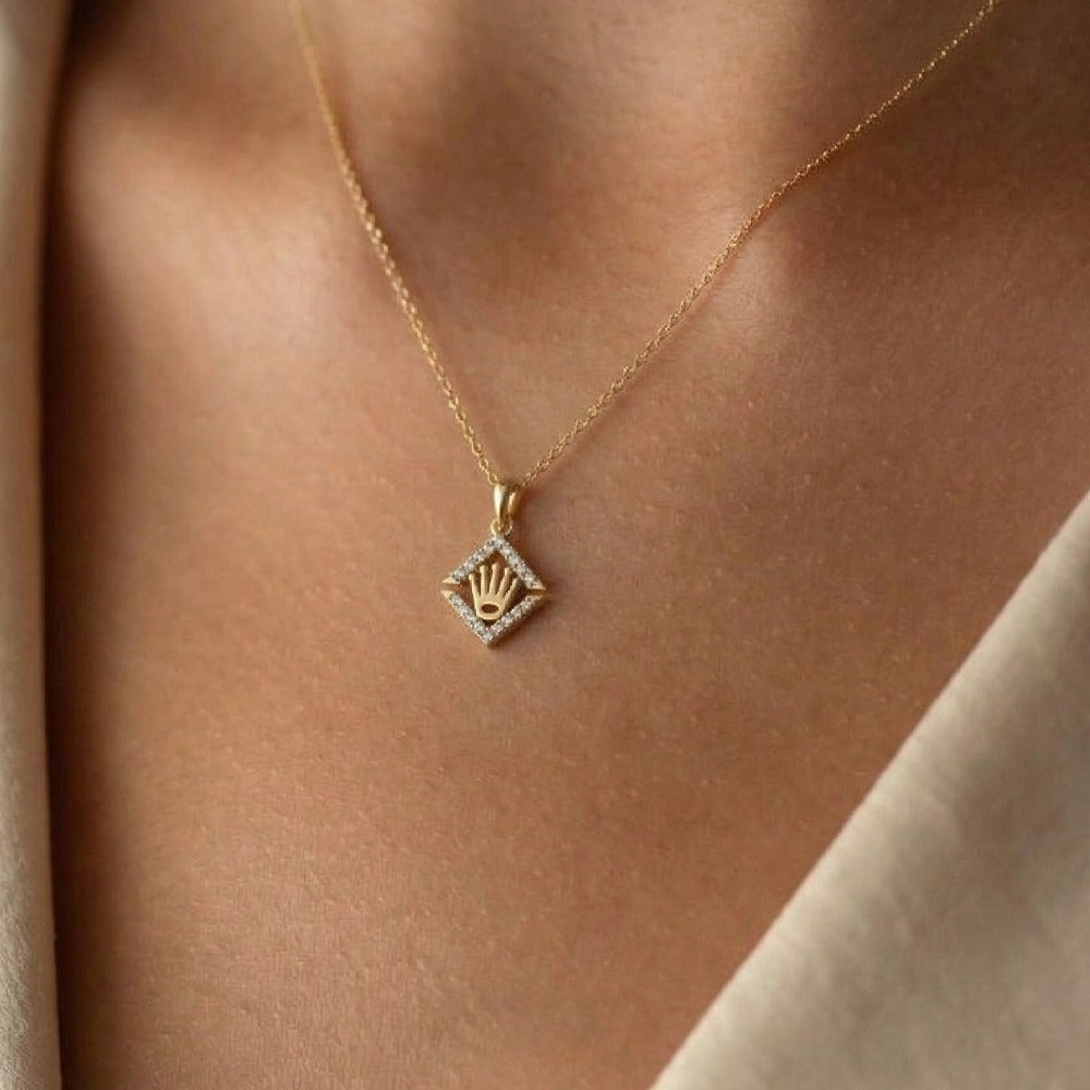 Gold and diamond pendant on a person's neck