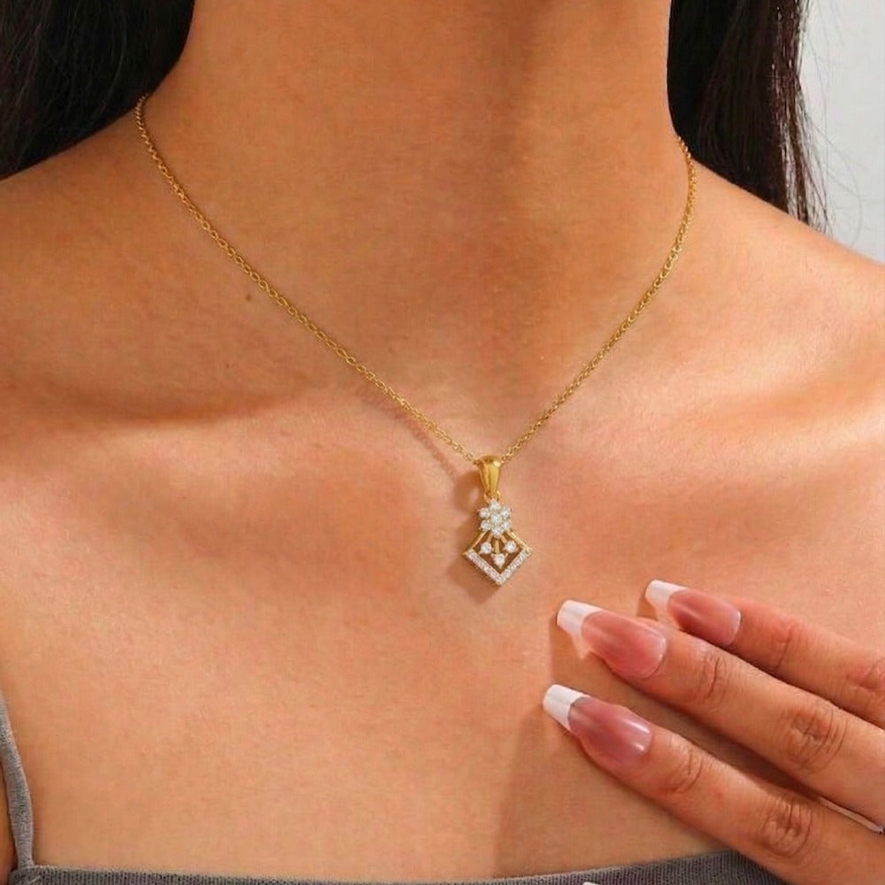 Gold and diamond pendant worn by a person