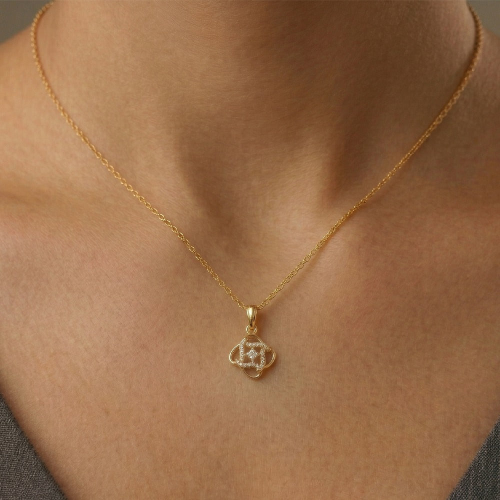Gold and diamond pendant on a person's neck