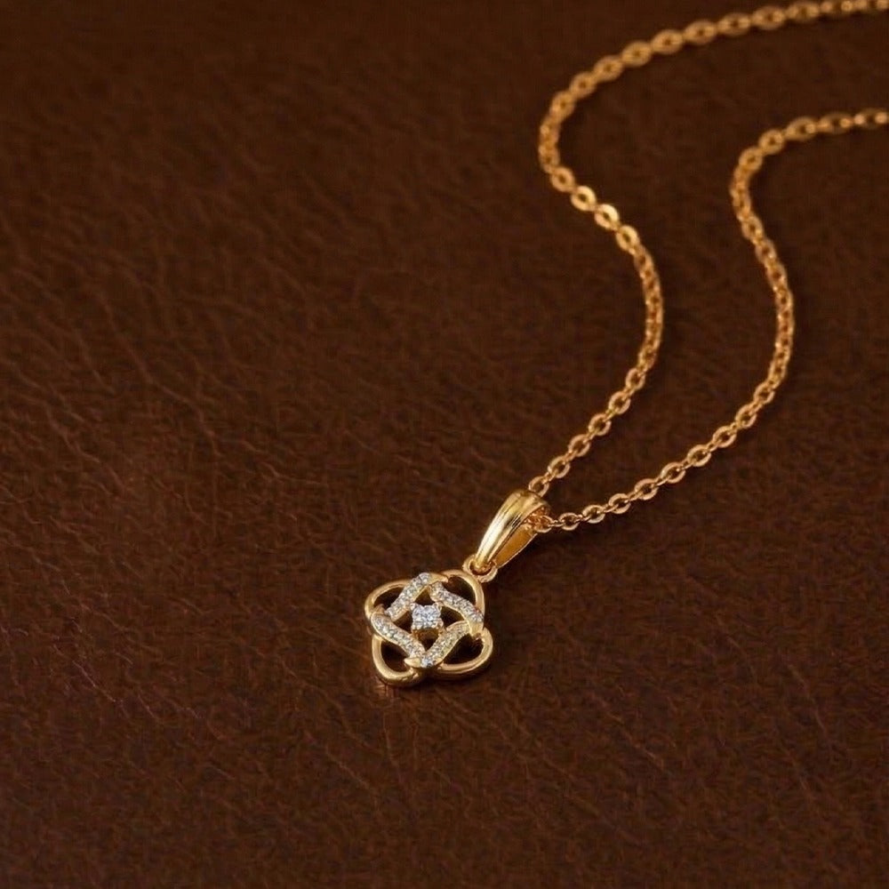 Gold and diamond pendant on a brown leather background