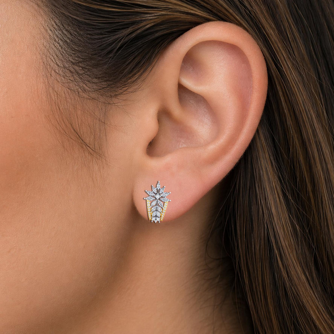 Close-up shot of an ear wearing a Gold & diamond floral women half hoop earrings in gold with marquise diamonds.