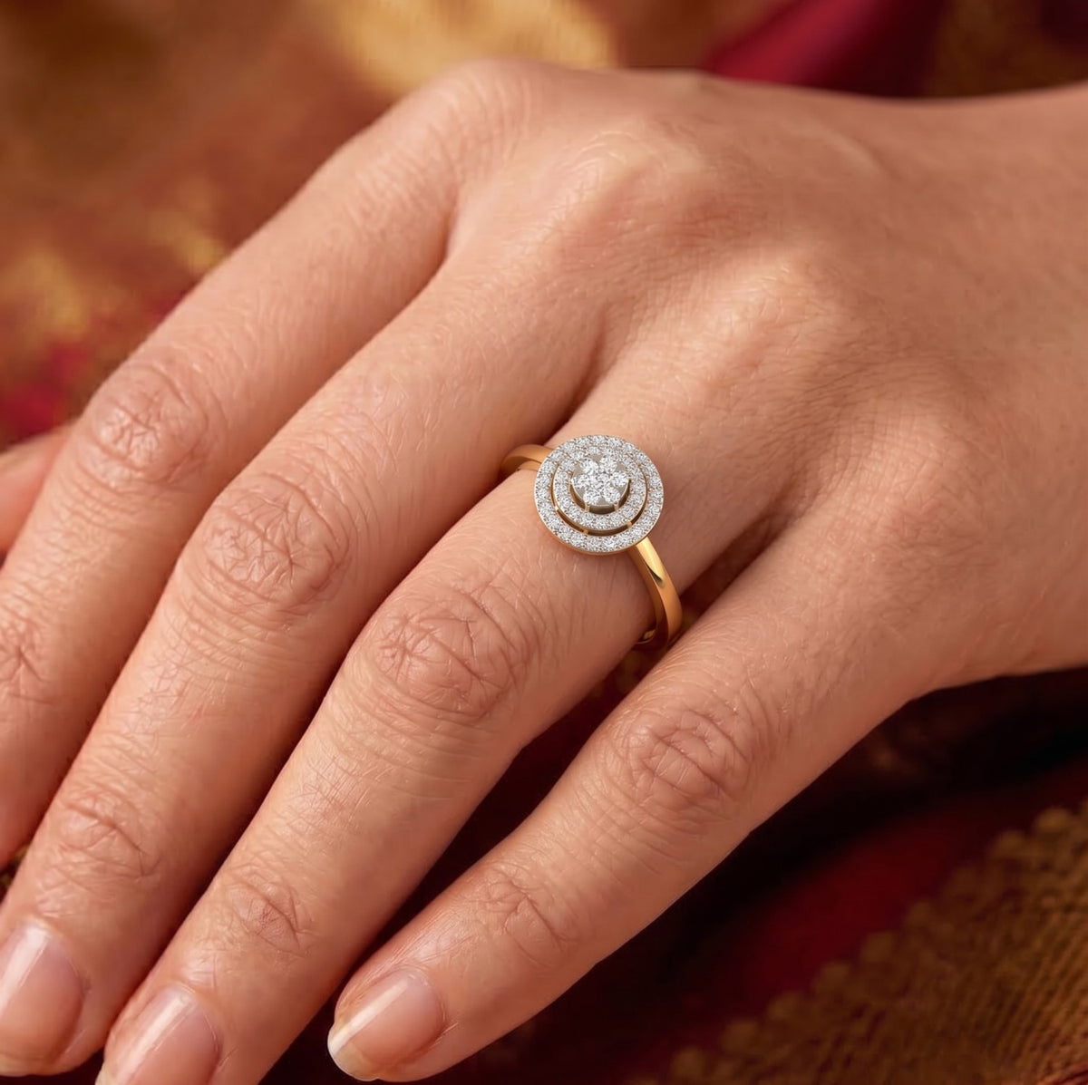 Close-up of a hand wearing a diamond ring with a blurred background