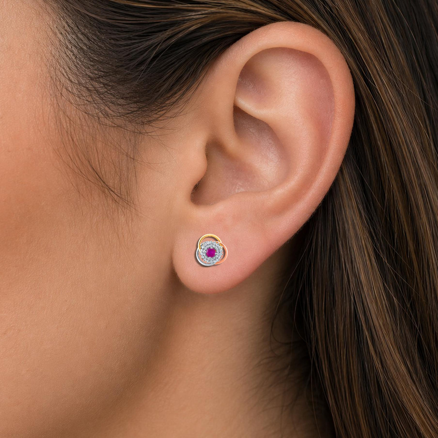Close-up shot of a gold & diamond women earrings crafted with a vibrant gemstone.