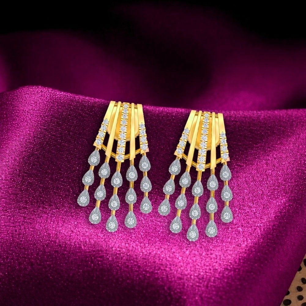 A pair of gold statement earrings with teardrop-shaped, displayed on a draped magenta satin fabric.