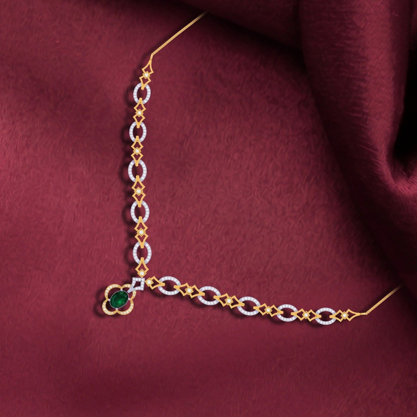 A gold and diamond with green gemstone, displayed on a draped red fabric background.