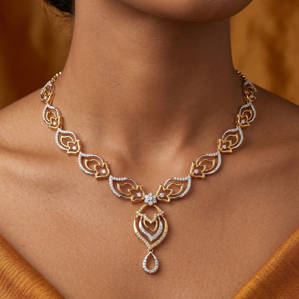Gold and diamond necklace on a person with a blurred background