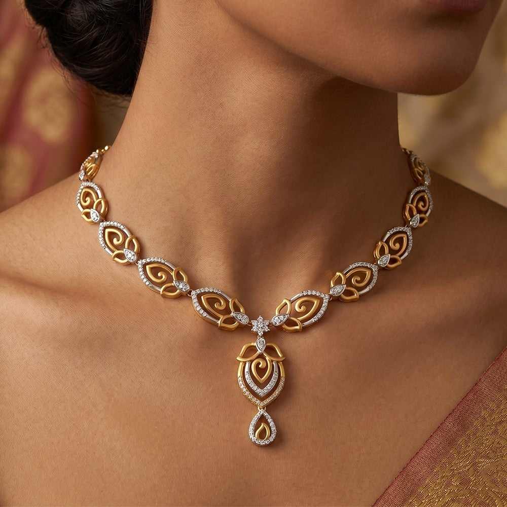 Gold and diamond necklace on a person with a blurred background