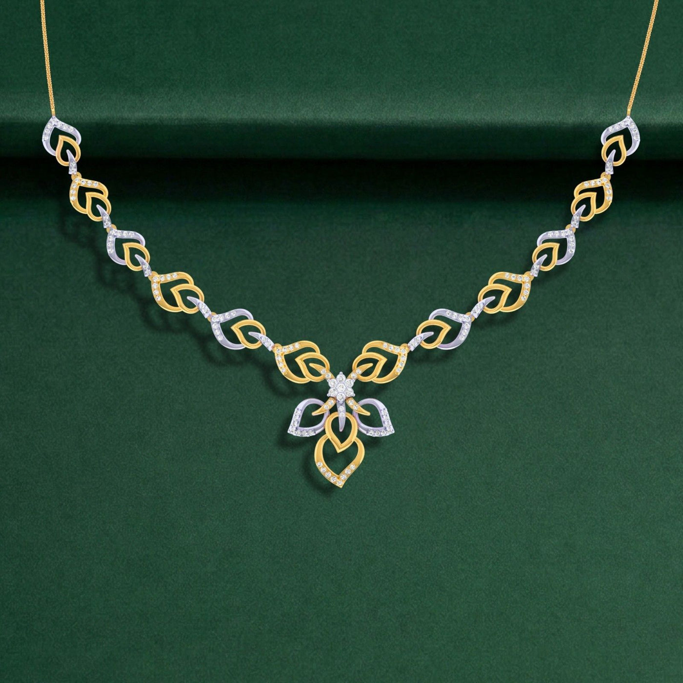 A gold and diamond necklace with diamond accents, displayed on a dark green velvet background.