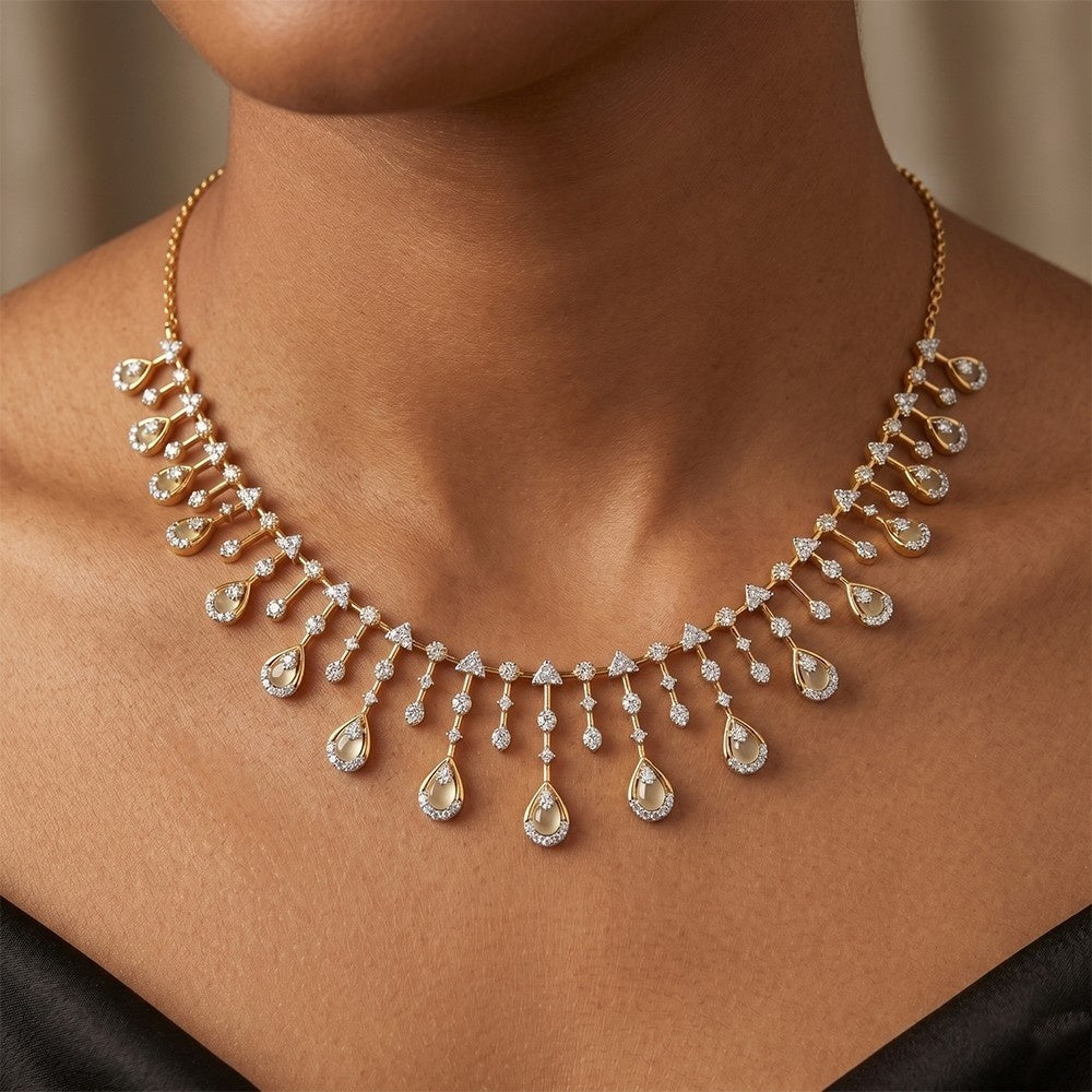 Gold necklace with teardrop-shaped diamonds on a person's neck