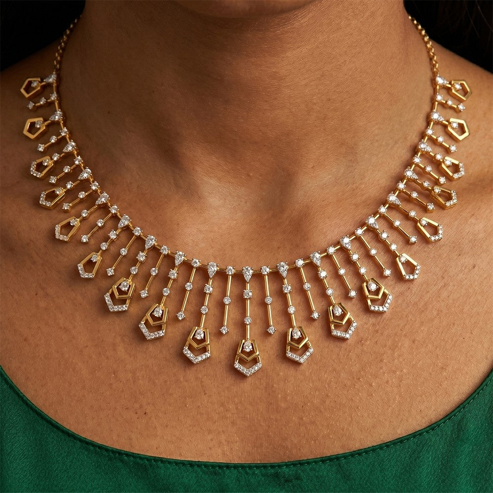 Gold necklace with diamond on a person wearing a green top.