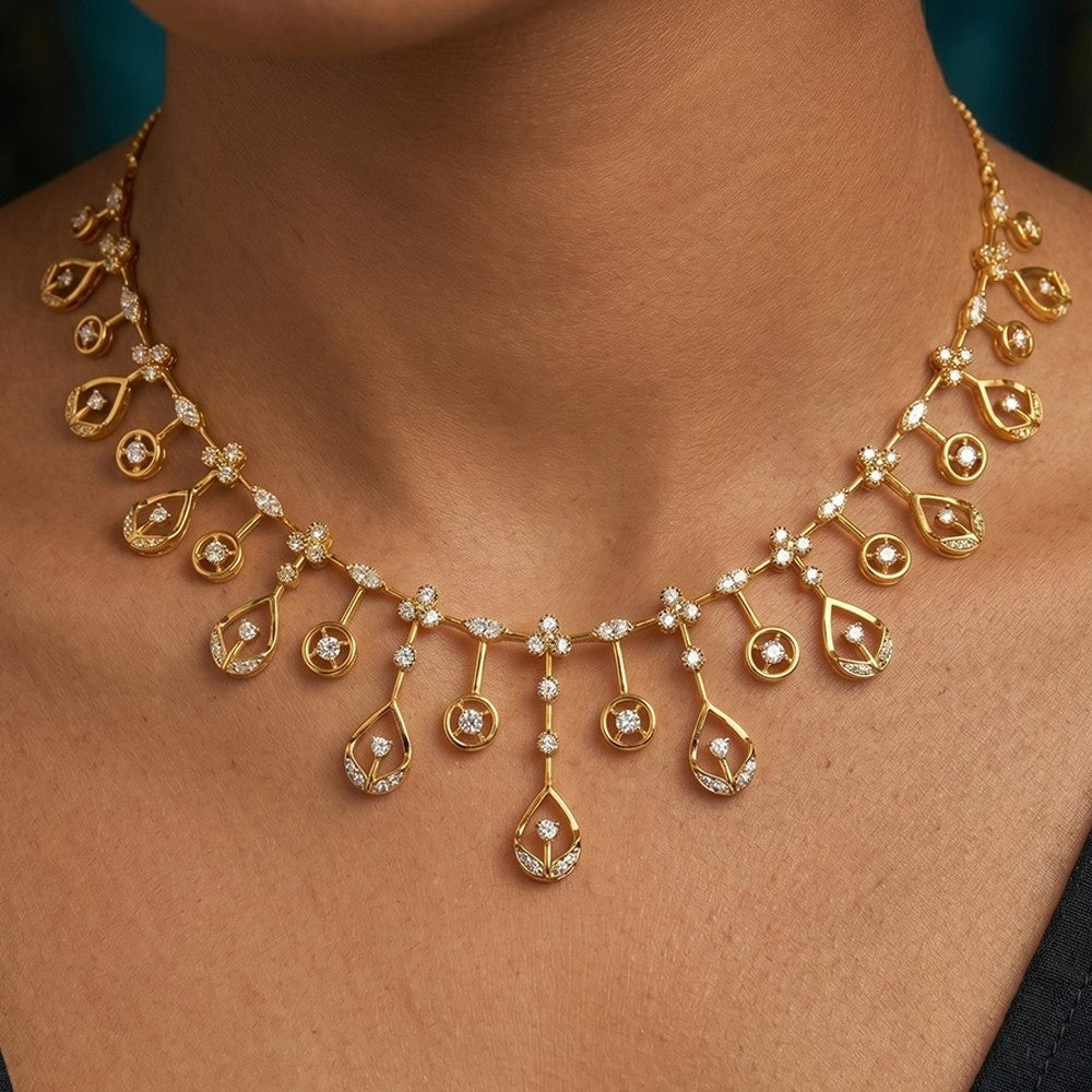 Gold and diamond necklace with teardrop-shaped pendants on a person's neck.