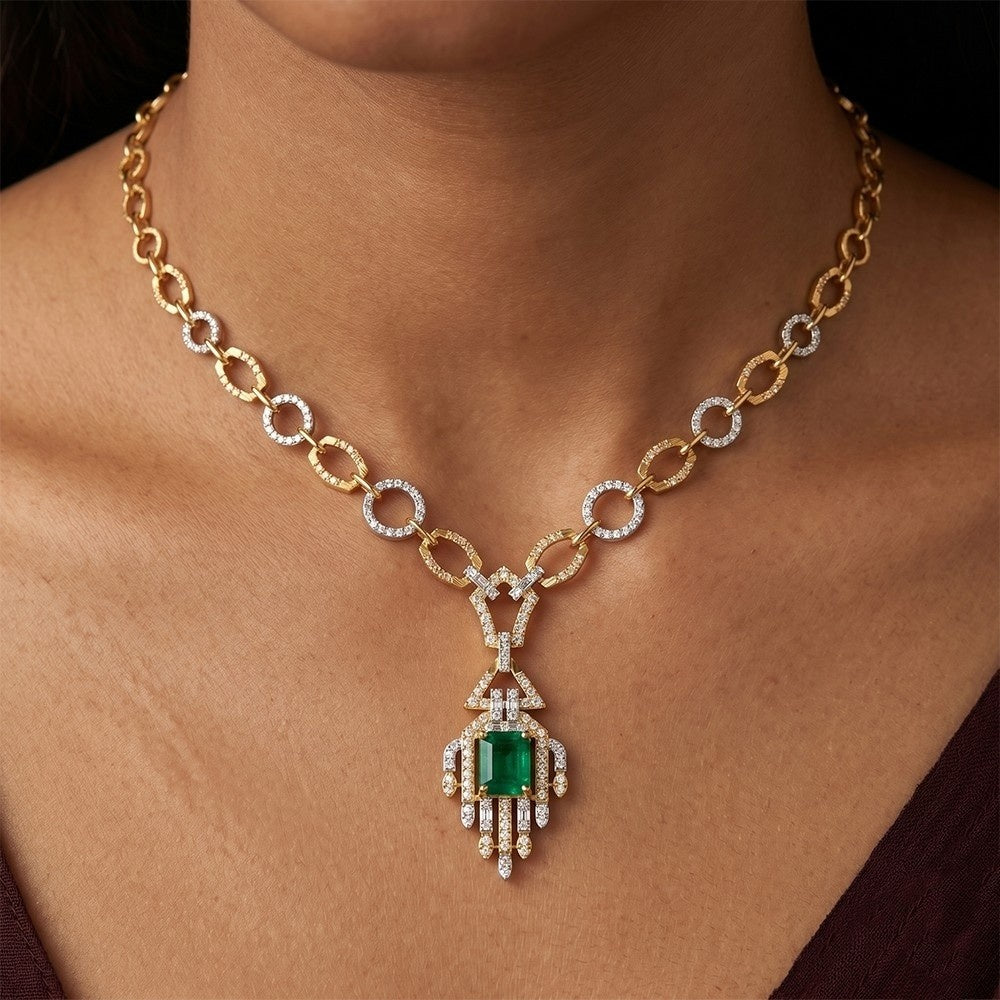 Gold and diamond necklace with a green gemstone on a person's neck.