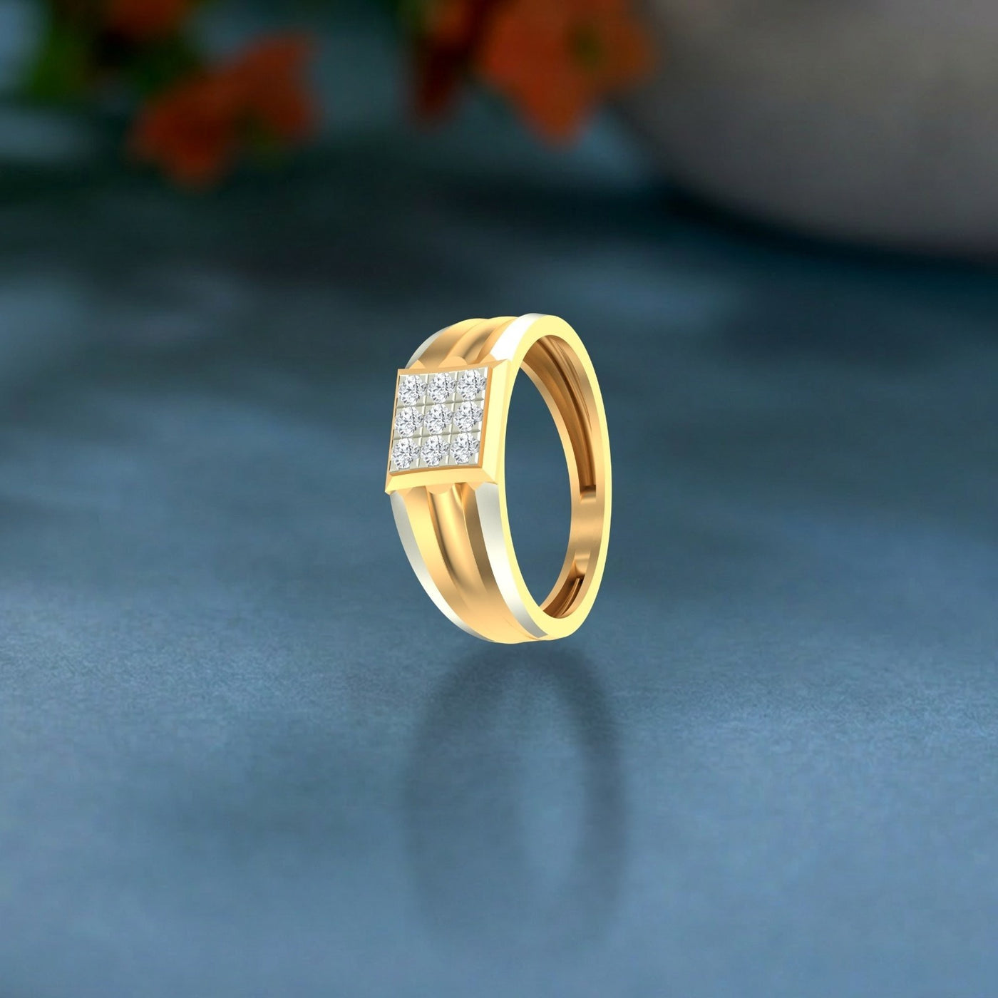 Gold ring with diamond accents on a reflective surface.