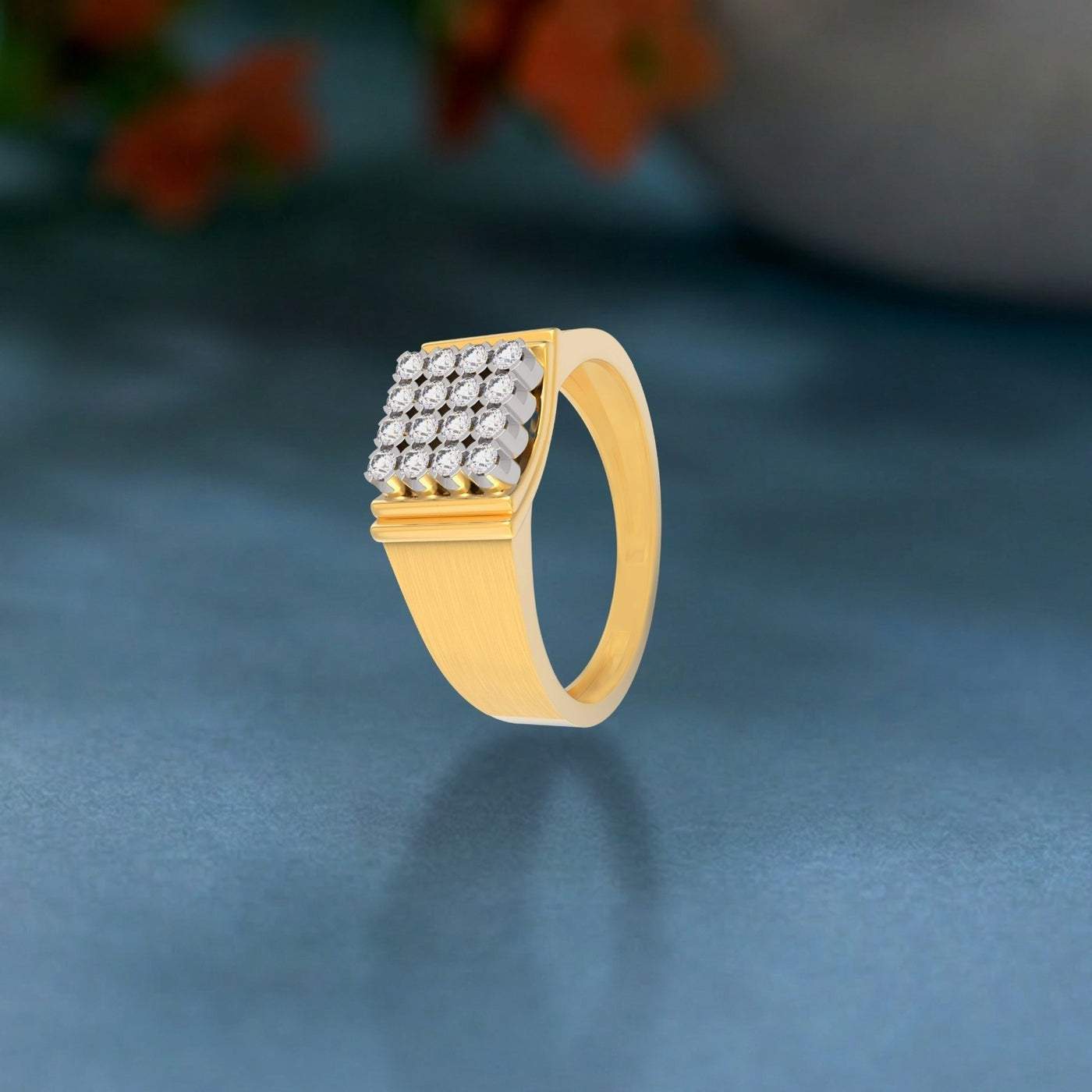 Gold ring with diamond accents on a dark blue background