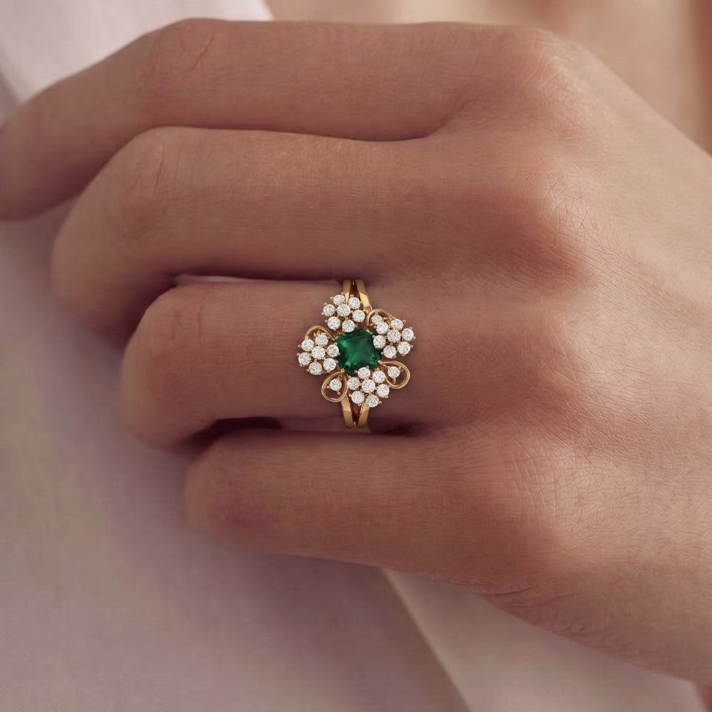 Gold ring with diamonds on a person's finger against a neutral background