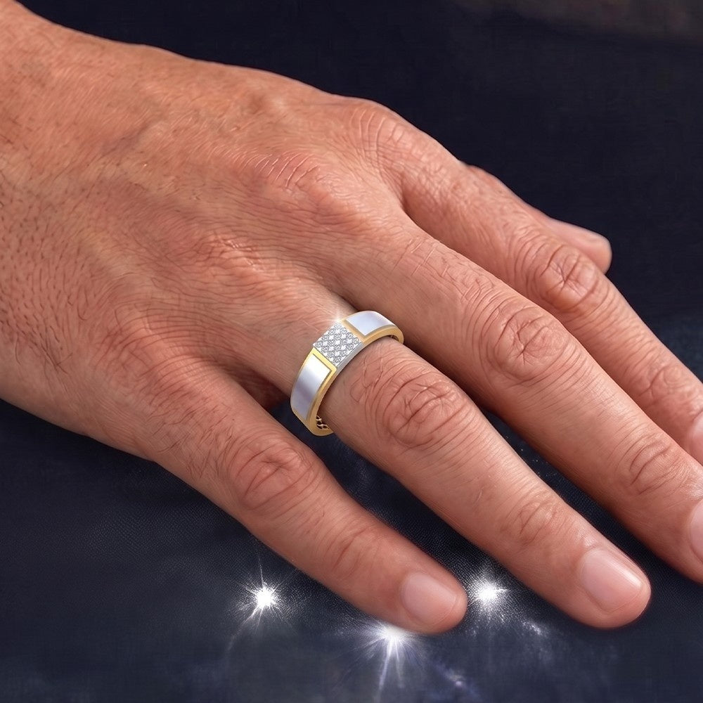 Hand wearing a gold and silver ring on a dark background