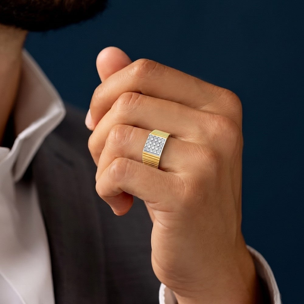 Hand wearing a gold ring with a diamond pattern on a dark background