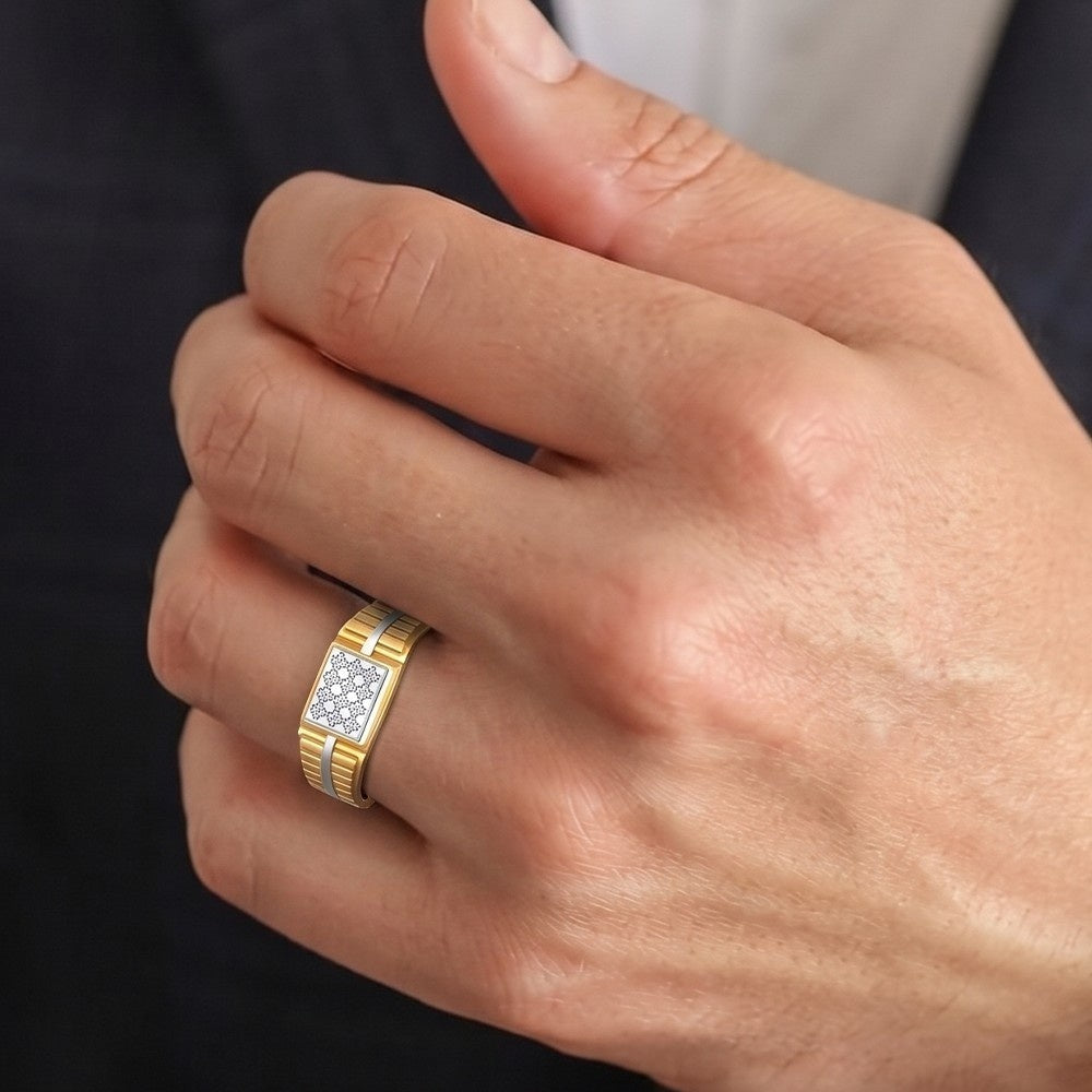 Gold ring with diamond pattern on a person's finger against a dark background