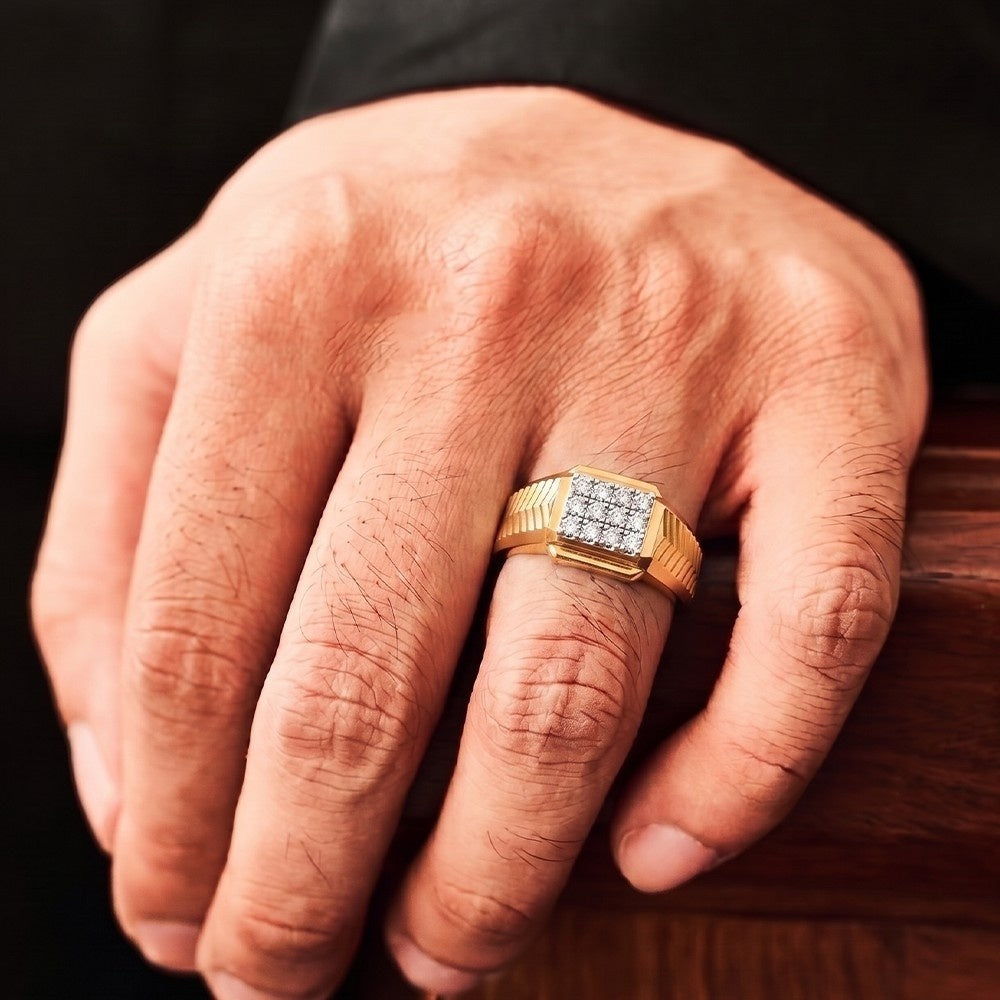 Hand wearing a gold ring with diamonds on a wooden surface