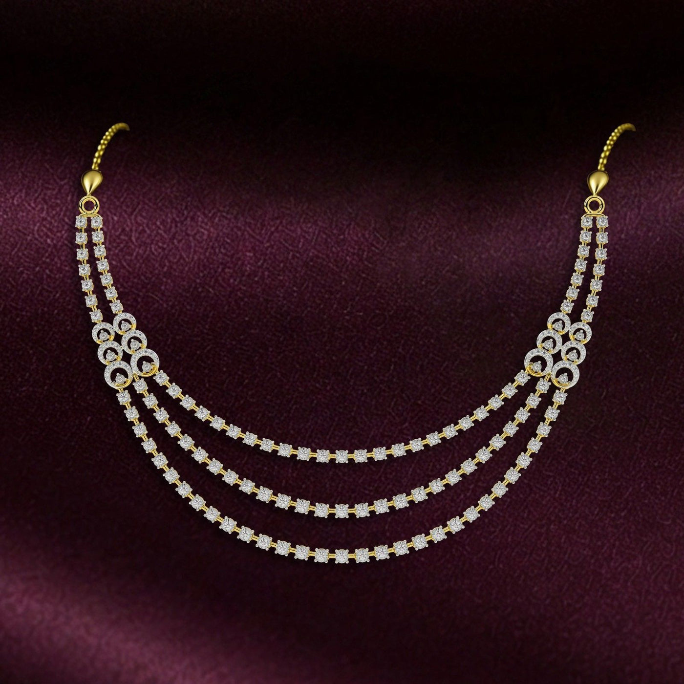 Gold and diamond necklace on a maroon background.
