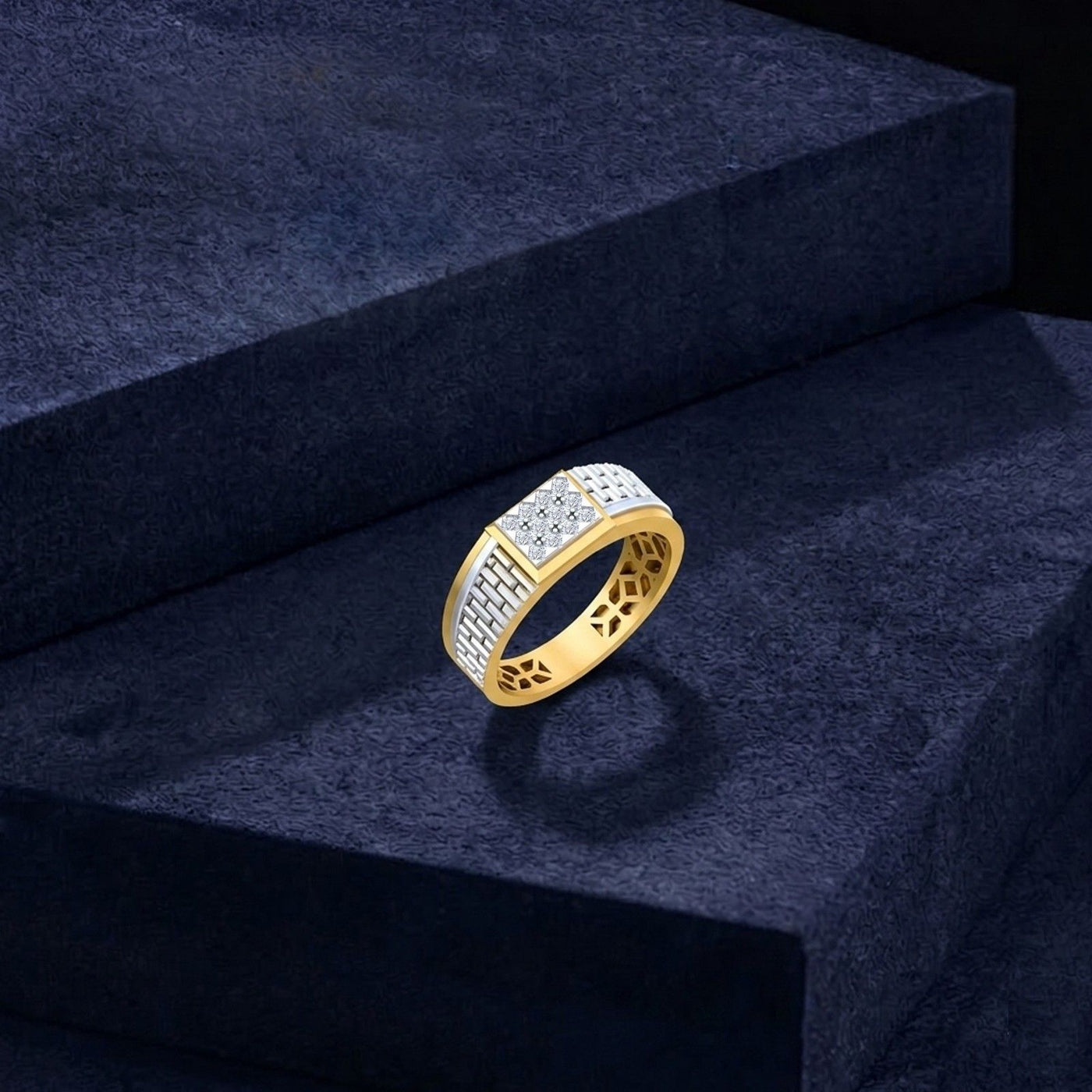 A gold ring with a rectangular band paved with clear stones, displayed on a dark textured velvet block.