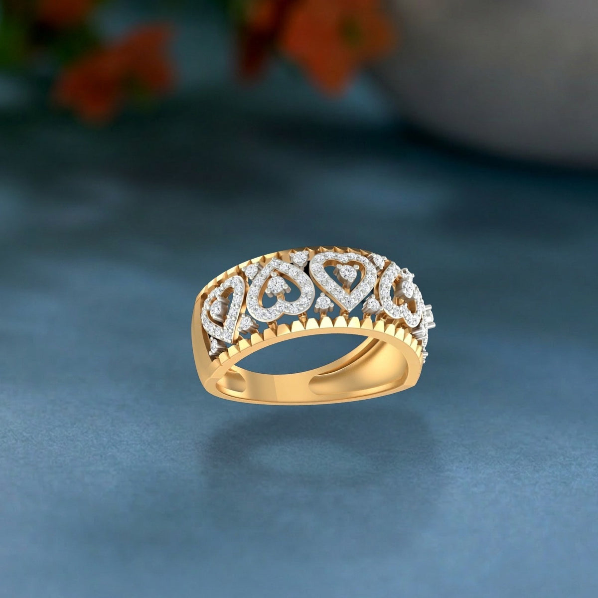 Gold ring with diamond accents on a blue background.