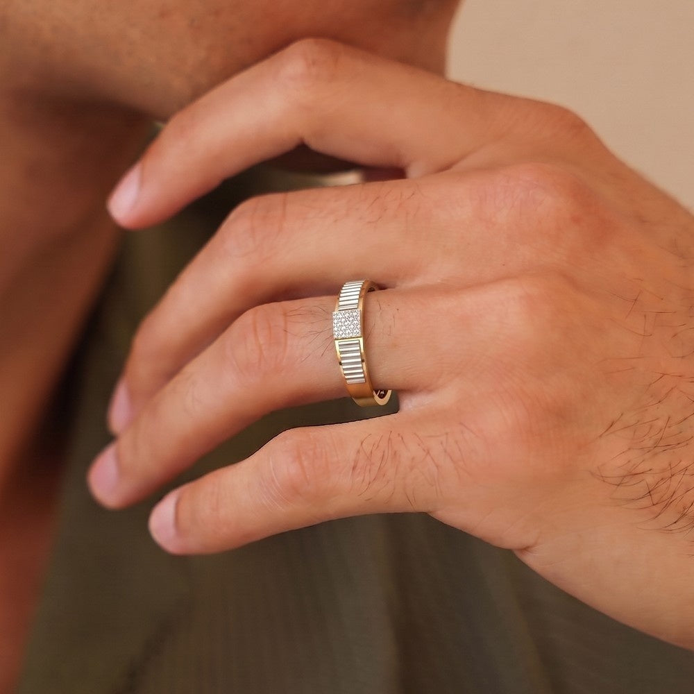 Close-up of a hand wearing a gold ring with a blurred background.