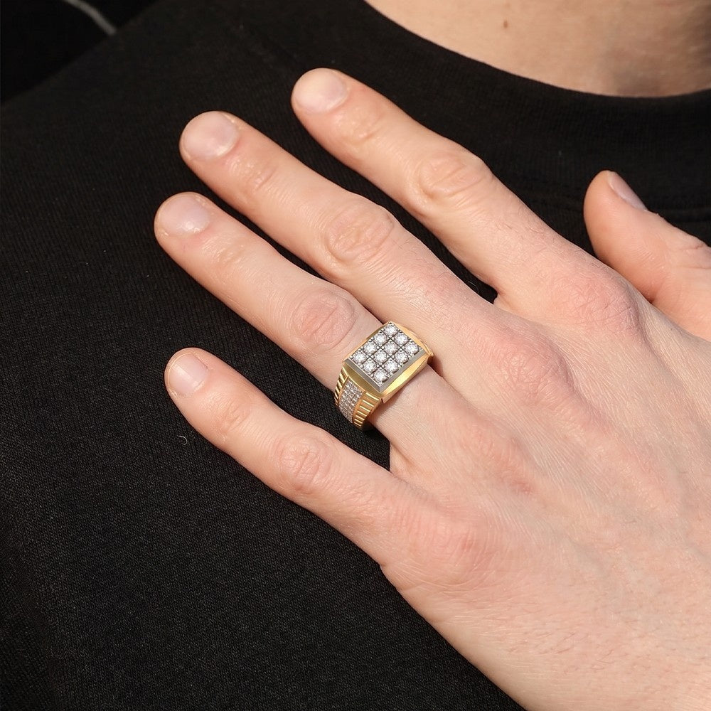 Hand wearing a gold ring with gemstones on a black background