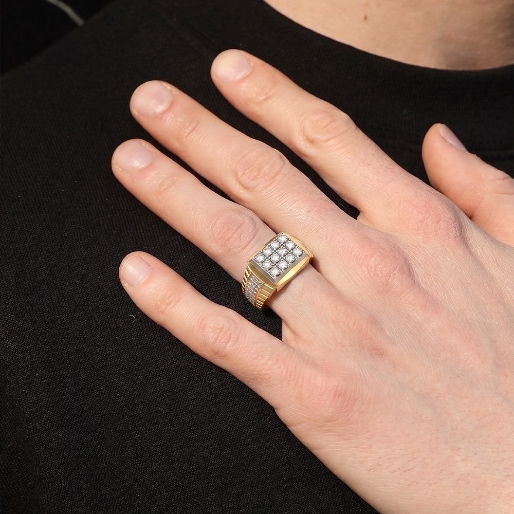 Hand wearing a gold ring with gemstones on a black background.