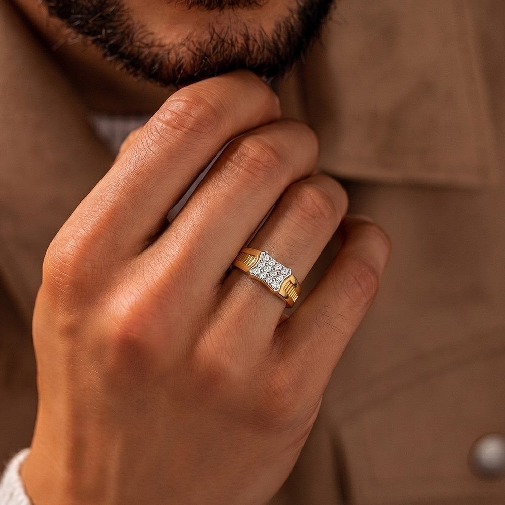 A close-up of a man's hand wearing a gold ring.