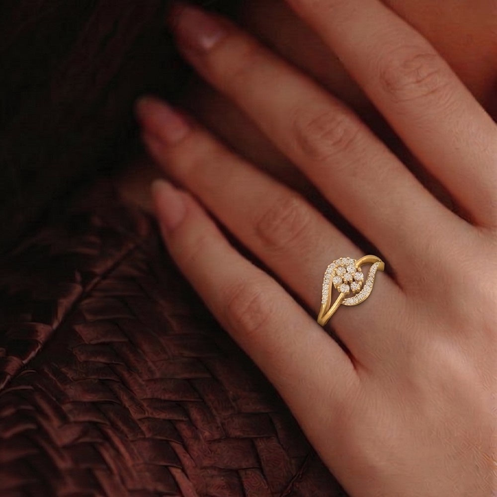 Gold ring with a diamond design on a hand against a dark background