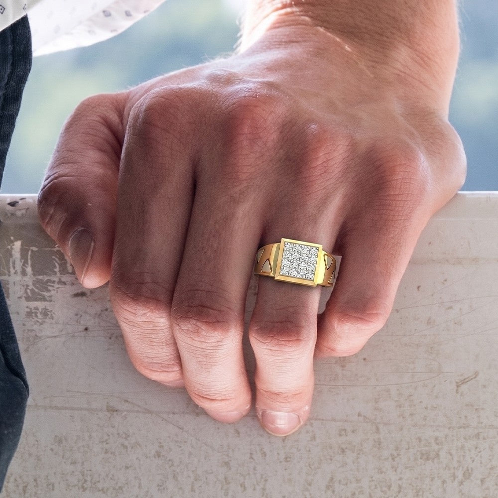 Hand wearing a gold ring with diamonds on a blurred background