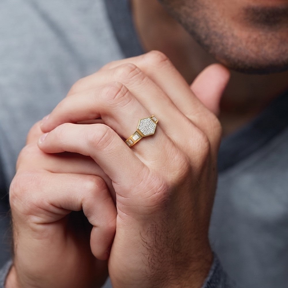 Close-up of a hand wearing a gold ring with a diamond, against a neutral background.