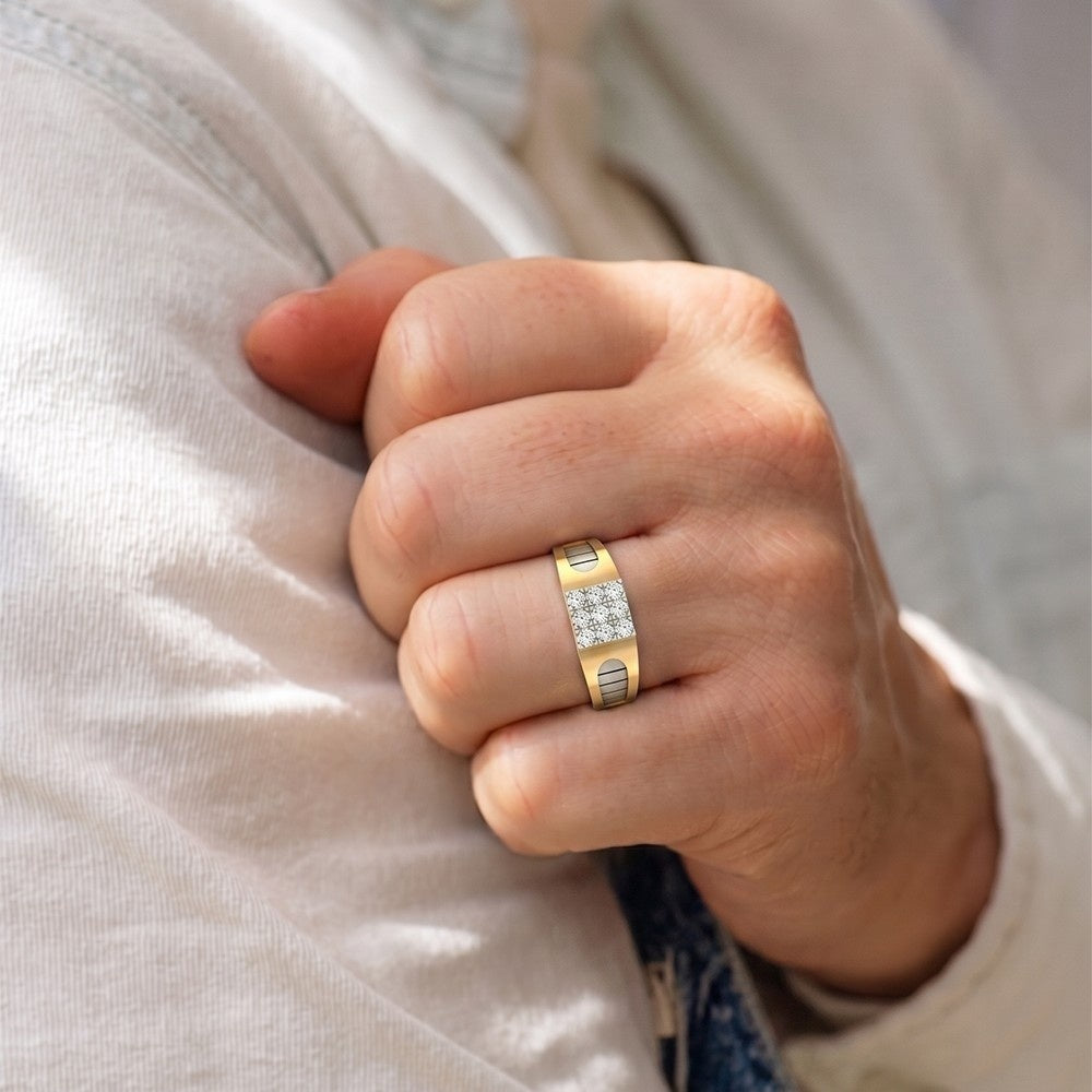 Hand wearing a gold ring with diamonds on a light background