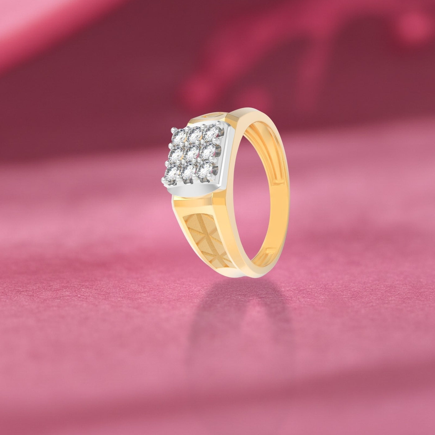 Gold ring with diamonds on a pink fabric background