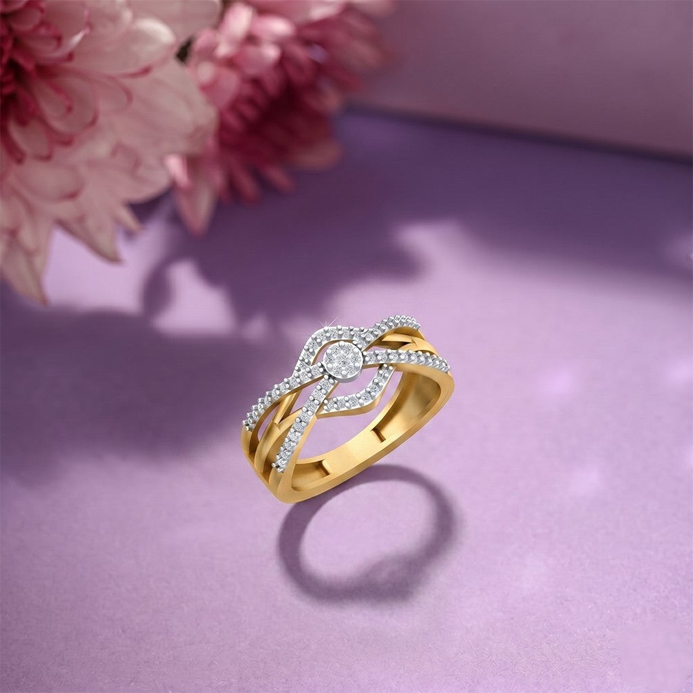 Gold ring with diamonds on a purple surface with pink flowers