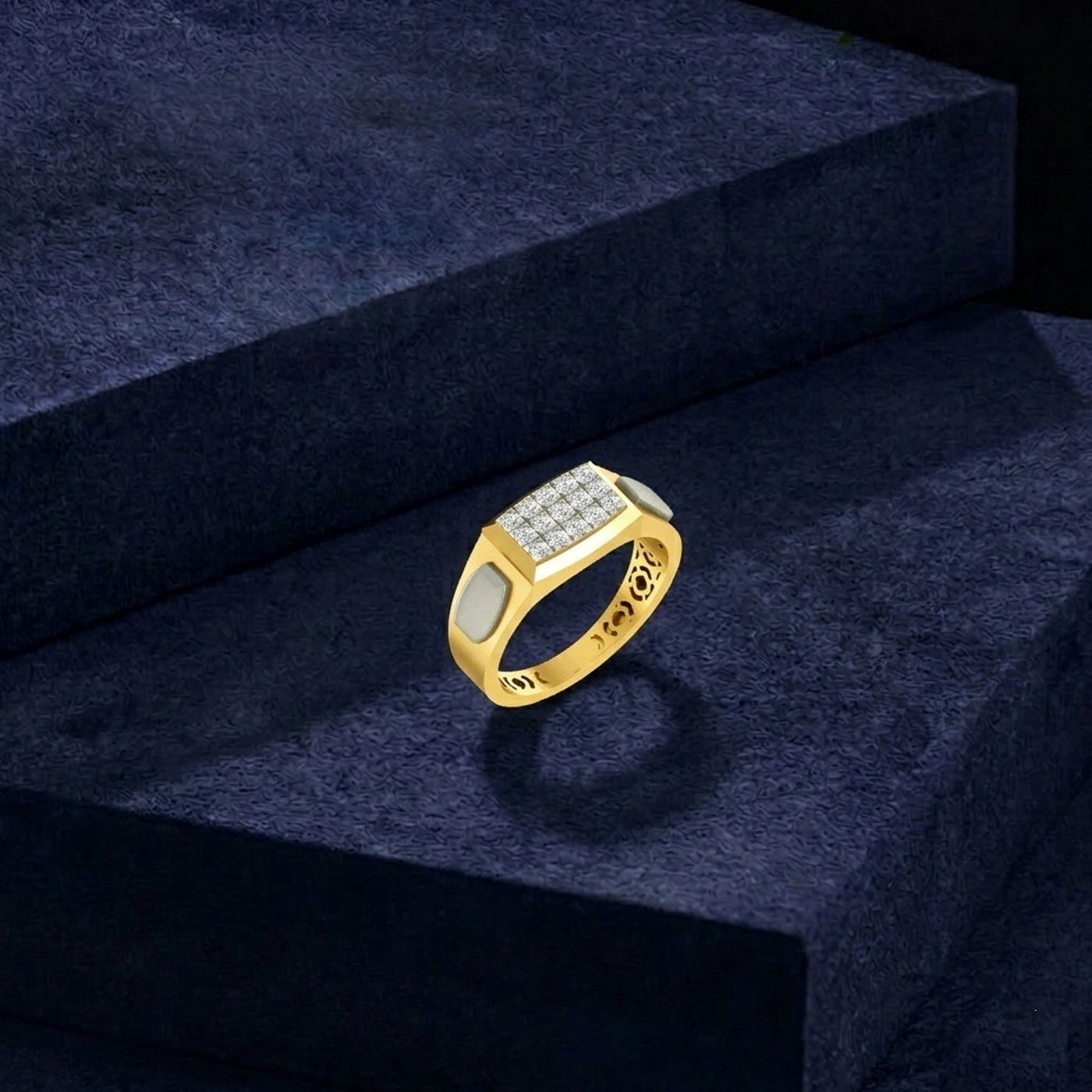 A gold signet-style ring with a rectangular, displayed on dark navy velvet steps.