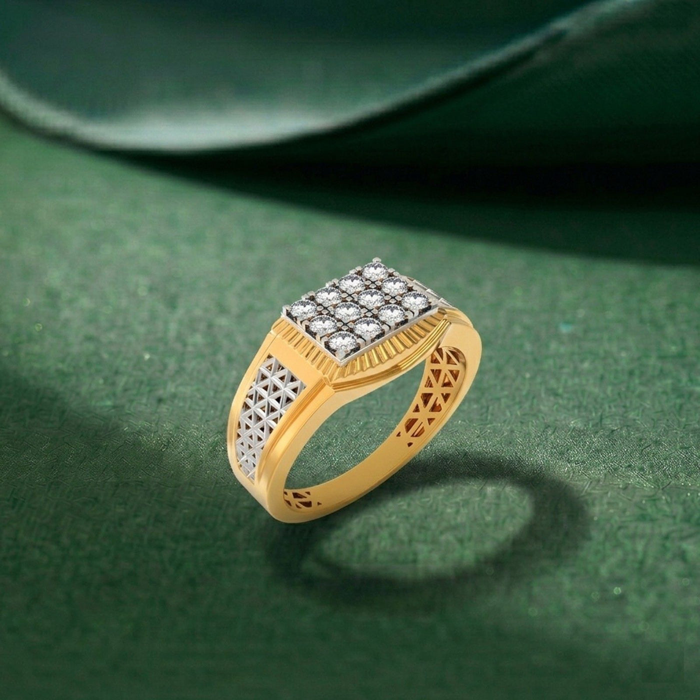 Gold ring with a square diamond cluster setting and geometric, displayed on a textured dark green surface.